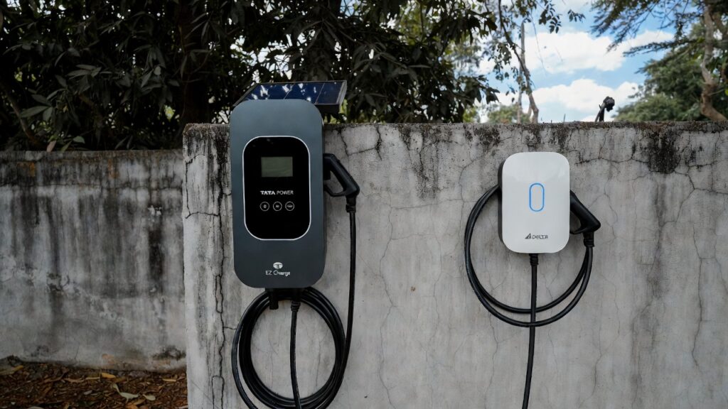 Weatherproof Tata Power EZ Charge and Delta AC Mini EV chargers mounted on an outdoor compound wall in Bengaluru, India – demonstrating IP65-rated durability against monsoon rain and dust in 2026 home EV charging setups